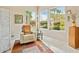 Sitting area offering natural light through three large windows with a chair and side table at 11216 E Appaloosa Pl, Scottsdale, AZ 85259