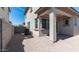 View of the backyard with a covered patio, gravel landscaping, and block wall providing privacy at 1193 E Spruce Dr, Chandler, AZ 85286