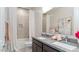 Stylish bathroom featuring double sinks with granite countertops and tiled shower at 1193 E Spruce Dr, Chandler, AZ 85286