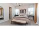 Bright bedroom featuring neutral décor, chandelier, large windows, and ensuite bathroom access at 1193 E Spruce Dr, Chandler, AZ 85286