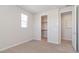 Carpeted bedroom with closet and open door to ensuite bathroom at 1193 E Spruce Dr, Chandler, AZ 85286