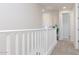 Upstairs hallway featuring white railings and neutral décor, leading to various rooms at 1193 E Spruce Dr, Chandler, AZ 85286