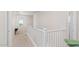 Well-lit hallway with white railing and a carpet runner leading to rooms at 1193 E Spruce Dr, Chandler, AZ 85286