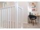 Hallway office nook featuring a built-in desk, comfortable chair, and stylish geometric artwork at 1193 E Spruce Dr, Chandler, AZ 85286