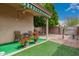 Cozy back porch with artificial turf, decorative plants and rocks, offering a serene outdoor experience at 121 N Ramada --, Mesa, AZ 85205