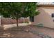 Spacious backyard is landscaped with drought-tolerant gravel, rock, and low-maintenance plants, ideal for the modern lifestyle at 121 N Ramada --, Mesa, AZ 85205