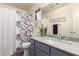 Bathroom featuring gray vanity, decorative shower curtain, mirror, and hardwood floors at 121 N Ramada --, Mesa, AZ 85205