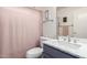 Updated bathroom showcasing a marble countertop, brushed nickel faucet, and a soft pink shower curtain at 121 N Ramada --, Mesa, AZ 85205