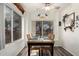 Bright dining area with a view of the outdoors through large windows, and a ceiling fan at 121 N Ramada --, Mesa, AZ 85205