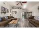 Inviting living room with wood-look floors, ceiling fan, and abundant natural light at 121 N Ramada --, Mesa, AZ 85205