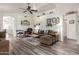 Bright living room featuring wood-look floors, ceiling fan, and archway to adjacent rooms at 121 N Ramada --, Mesa, AZ 85205