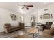 Bright living room featuring wood-look floors, ceiling fan, and views of the kitchen at 121 N Ramada --, Mesa, AZ 85205