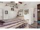 Bedroom with decorative headboard, large dresser with mirror, ensuite bathroom, and ceiling fan at 121 N Ramada --, Mesa, AZ 85205