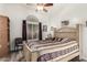 Neutral bedroom with neutral walls, hardwood floors, window with curtains, and view to the backyard at 121 N Ramada --, Mesa, AZ 85205