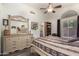 Bright bedroom with large dresser, ceiling fan, and view to the ensuite bathroom at 121 N Ramada --, Mesa, AZ 85205