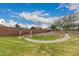 Community picnic area with metal table and grill surrounded by lush green grass and a walking path at 121 N Ramada --, Mesa, AZ 85205