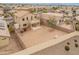 Aerial view of a neighborhood featuring a large backyard with a perimeter brick wall and solar panels on nearby roofs at 14450 N 132Nd Dr, Surprise, AZ 85379