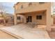 Covered back patio with a dining table and a partially fenced-in yard at 14450 N 132Nd Dr, Surprise, AZ 85379