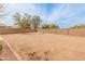 Spacious backyard enclosed by a brick wall, featuring a picnic table in the center of the yard at 14450 N 132Nd Dr, Surprise, AZ 85379