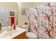 Bathroom featuring a vanity, toilet, and shower with floral curtain at 14450 N 132Nd Dr, Surprise, AZ 85379