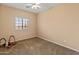 Simple bedroom showcasing a neutral color scheme, carpeted flooring and a bright window at 14450 N 132Nd Dr, Surprise, AZ 85379