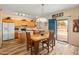 Bright dining area featuring wood-look floors, a modern light fixture and slider access to the backyard at 14450 N 132Nd Dr, Surprise, AZ 85379