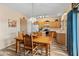 Charming dining area featuring a wooden table with chairs and a view into the kitchen at 14450 N 132Nd Dr, Surprise, AZ 85379