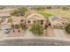 Aerial view of a two-story home with desert landscaping, a driveway, and a well-maintained lawn in the neighborhood at 14450 N 132Nd Dr, Surprise, AZ 85379