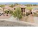 Aerial view of a two-story home with desert landscaping, a driveway, and a well-maintained lawn in the neighborhood at 14450 N 132Nd Dr, Surprise, AZ 85379