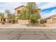 Two-story home with a neutral color scheme, stone accents, desert landscaping, and an attached two-car garage at 14450 N 132Nd Dr, Surprise, AZ 85379