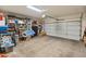 Spacious two-car garage featuring ample storage shelves and well-lit with an electric door opener at 14450 N 132Nd Dr, Surprise, AZ 85379