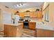 Bright kitchen features modern appliances, ample counter space, and wooden cabinets at 14450 N 132Nd Dr, Surprise, AZ 85379