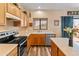 Well-lit kitchen with wooden cabinets, stainless steel appliances, and a view to the outside at 14450 N 132Nd Dr, Surprise, AZ 85379