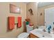 A charming powder room with lovely decor and warm earth-tone colors at 14450 N 132Nd Dr, Surprise, AZ 85379