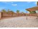 Spacious backyard featuring a covered patio, paver flooring, and block fence at 16157 W Moreland St, Goodyear, AZ 85338