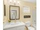 Bright bathroom featuring neutral tones, a wide mirror, and modern fixtures at 16157 W Moreland St, Goodyear, AZ 85338