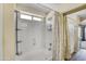 Bright bathroom featuring a tub with shower, neutral tiling and modern fixtures at 16157 W Moreland St, Goodyear, AZ 85338