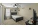 Cozy bedroom featuring carpet flooring, fan, and good lighting at 16157 W Moreland St, Goodyear, AZ 85338