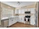 Modern kitchen with stainless steel appliances, white cabinets, and ample counter space, perfect for cooking at 16157 W Moreland St, Goodyear, AZ 85338