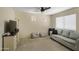 Inviting living room with cozy sofa, ceiling fan, and natural light at 16157 W Moreland St, Goodyear, AZ 85338