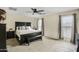 Comfortable main bedroom with a spacious bed, ceiling fan, and natural light at 16157 W Moreland St, Goodyear, AZ 85338