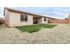 View of the backyard featuring turf, a covered patio, and gravel at 17810 W Straight Arrow Ln, Surprise, AZ 85387