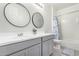 Stylish bathroom featuring dual sinks, modern vanity, and a shower at 17810 W Straight Arrow Ln, Surprise, AZ 85387