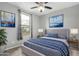 Comfortable bedroom with ceiling fan, natural light, and attractive nautical-themed decor at 17810 W Straight Arrow Ln, Surprise, AZ 85387