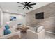 Elegant living room featuring accent wall, ceiling fan, and comfortable seating at 17810 W Straight Arrow Ln, Surprise, AZ 85387