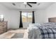 Inviting main bedroom featuring a plush bed, a large window, and a dresser at 17810 W Straight Arrow Ln, Surprise, AZ 85387