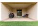 A covered patio with a grill, sliding glass doors, and blue cushioned chair set at 17810 W Straight Arrow Ln, Surprise, AZ 85387