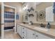 Bathroom with double sinks, decorative mirrors, and a view into the shower area at 18187 E Via Jardin --, Gold Canyon, AZ 85118