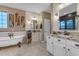 Bathroom with a soaking tub, granite counters, dual sinks and decorative mirrors at 18187 E Via Jardin --, Gold Canyon, AZ 85118