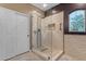 Modern bathroom with a glass enclosed shower, beige tile, and bronze fixtures at 18187 E Via Jardin --, Gold Canyon, AZ 85118